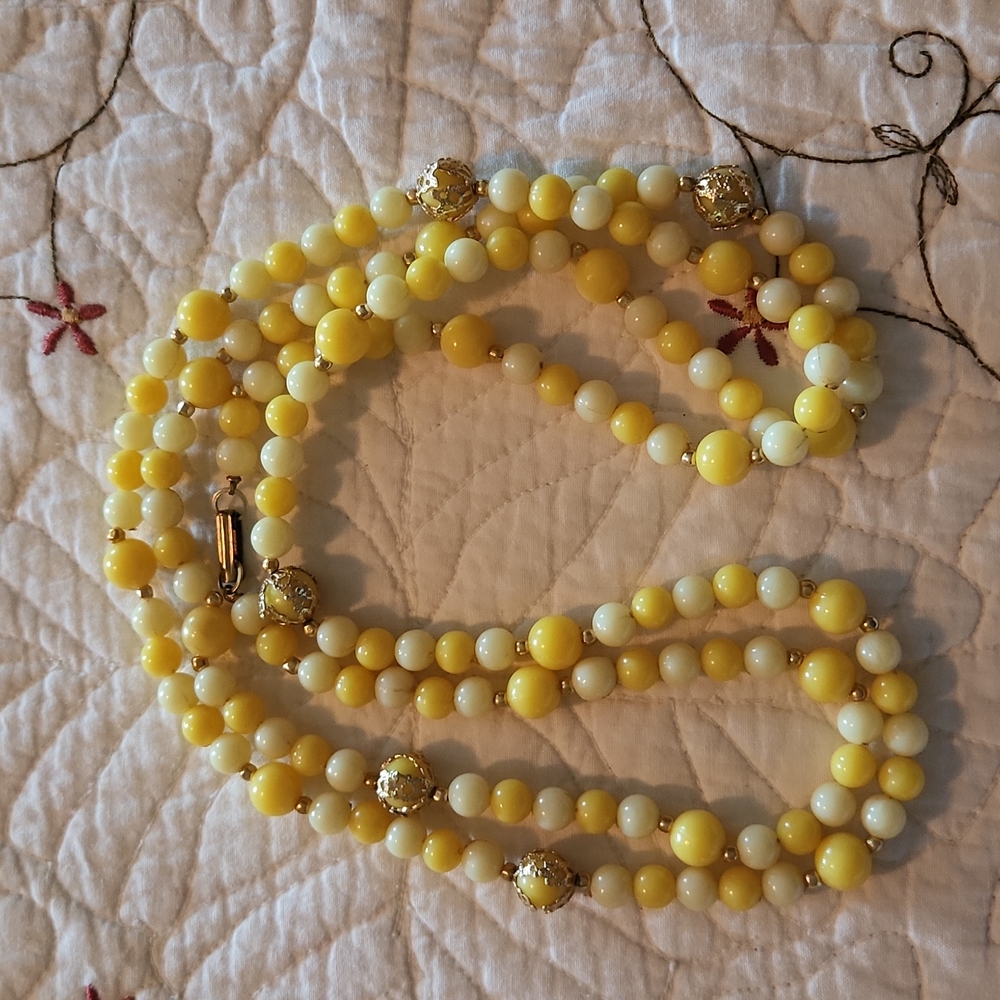 Yellow and gold tone plastic bead necklace